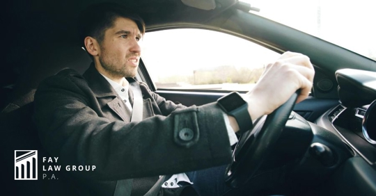 man driving a car